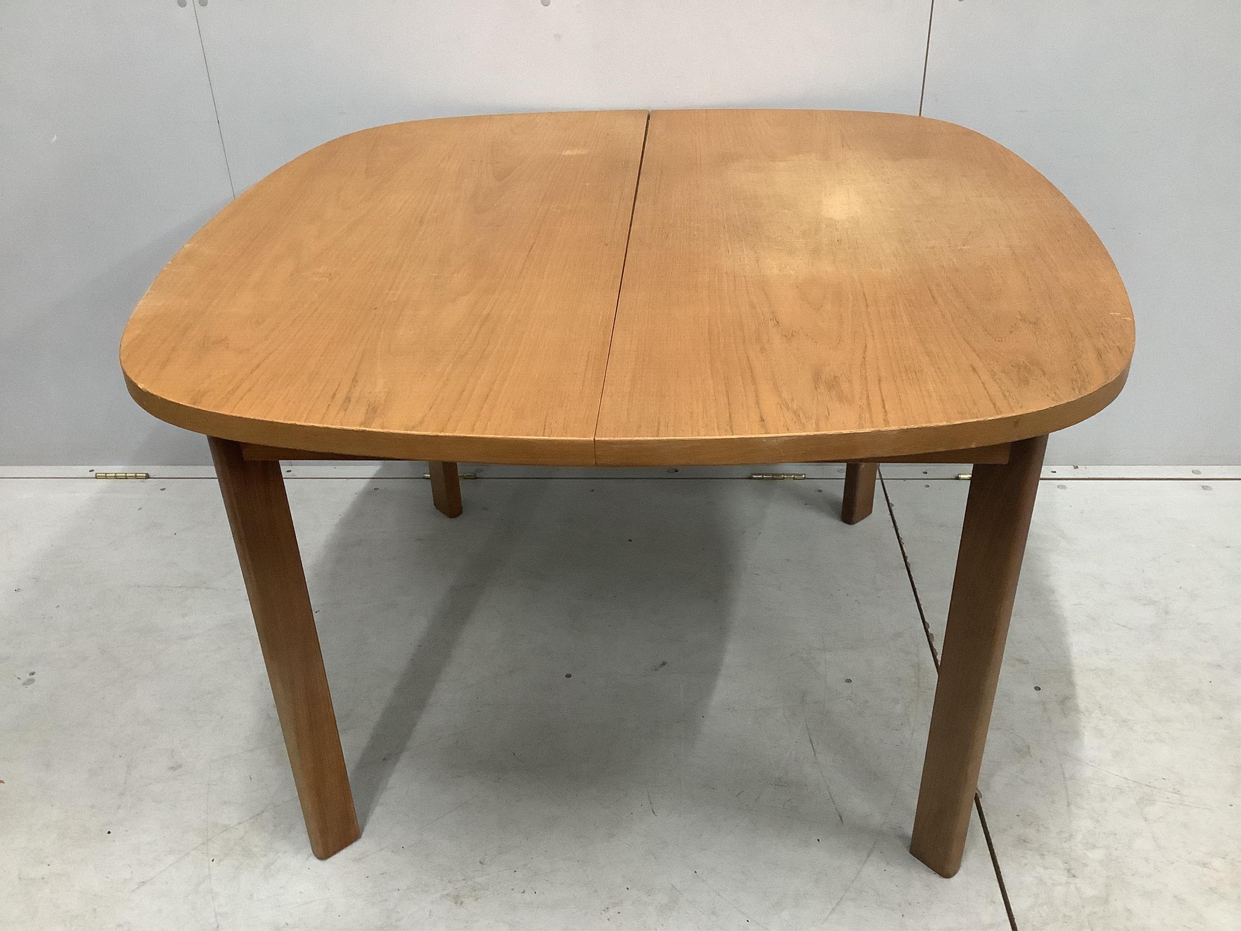 A mid century G Plan teak extending dining table, 158cm extended, depth 112cm, height 72cm and four chairs. Condition - fair to good